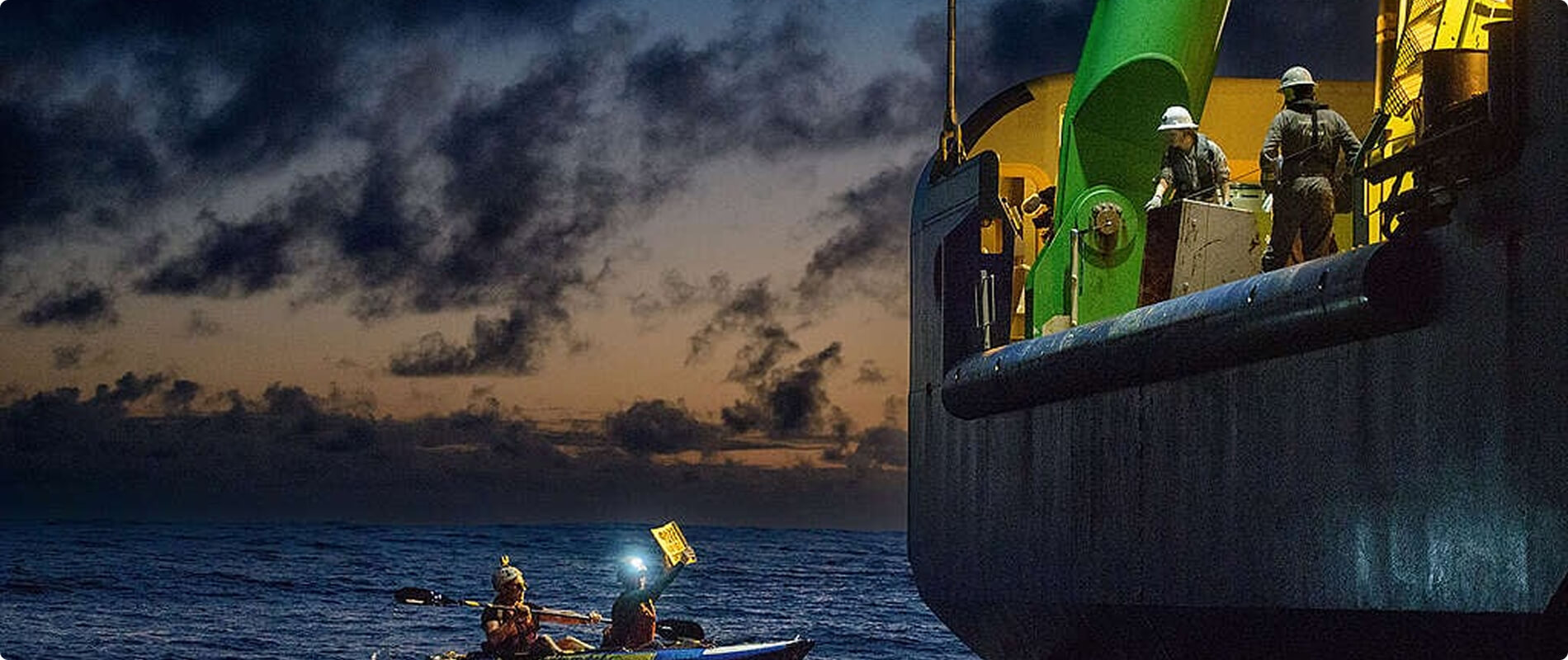 Imbarcazioni di Greenpeace in mare al tramonto.